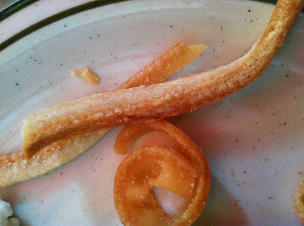 Close-up view of swirled bread on a white speckled plate.