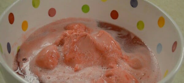 Raspberry sherbet and lemon-lime soda in a colorful polka dot mixing bowl.