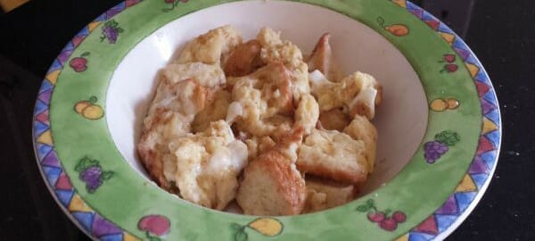 A serving of baked French toast in a colorful bowl.