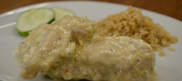 A white plate with a serving of Creamy Italian Chicken, white rice, and zucchini slices.