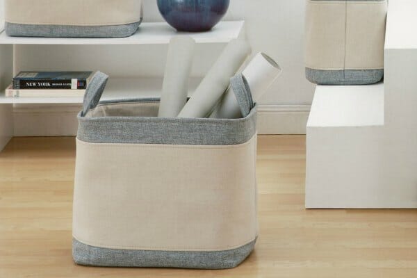 Fabric storage bins in Ivory and gray heather, next to white shelves and steps.
