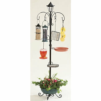 A black metal bird feeder station with five hooks, two bowls, and a planter on the bottom.