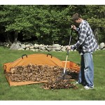 A man in a plaid shirt raking leaves into an orange EZ Leaf Hauler.