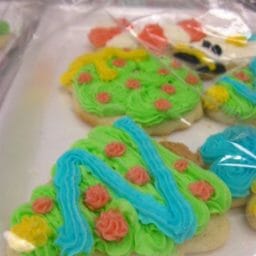 A close-up view of decorated Christmas sugar cookies on a tray.