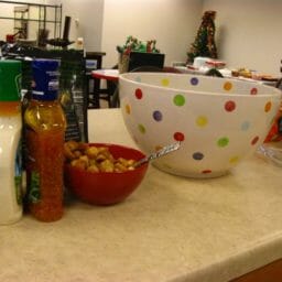 A large polka dot bowl on an office counter, next to salad dressings and croutons.