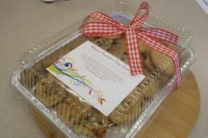 A foiled box of chocolate chip cookies with a red check bow, celebrating Founders Day.