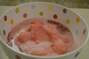 Raspberry sherbet and lemon-lime soda in a colorful polka dot mixing bowl.