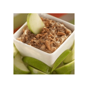 A square white bowl filled with toffee apple dip, and slices of Granny Smith apples.