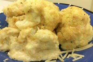 Close-up of a serving of Cheesy Cauliflower on a blue plate.
