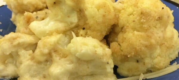 Close-up of a serving of Cheesy Cauliflower on a blue plate.