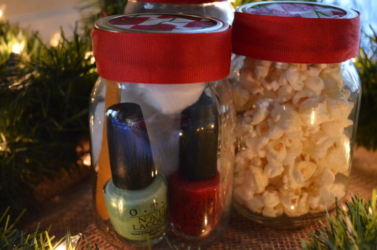 Two gift Mason jars, one filled with nail polish, files, and cotton balls, the other with popcorn.
