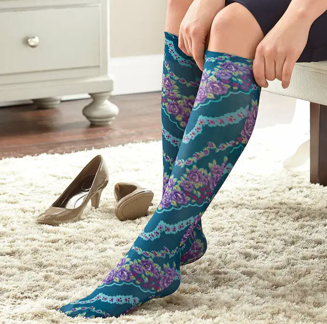 teal and purple compression socks on a women's legs