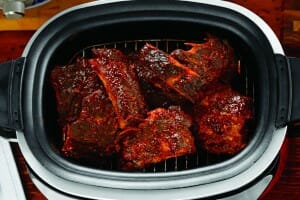 Barbeque Ribs on a rack inside a slow cooker.