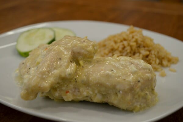 A white plate with a serving of Creamy Italian Chicken, white rice, and zucchini slices.