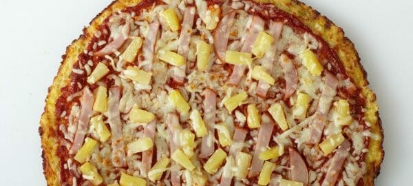 A homemade Hawaiian pizza with chunks of Canadian bacon and pineapple.