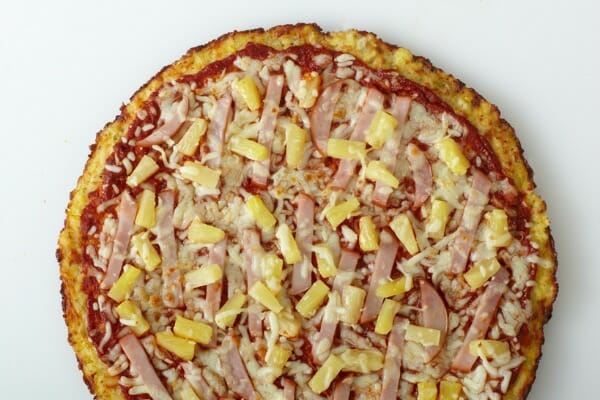 A homemade Hawaiian pizza with chunks of Canadian bacon and pineapple.