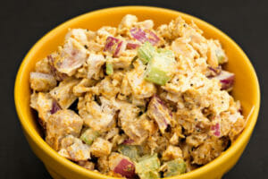 A yellow bowl filled with Curry Chicken Salad.