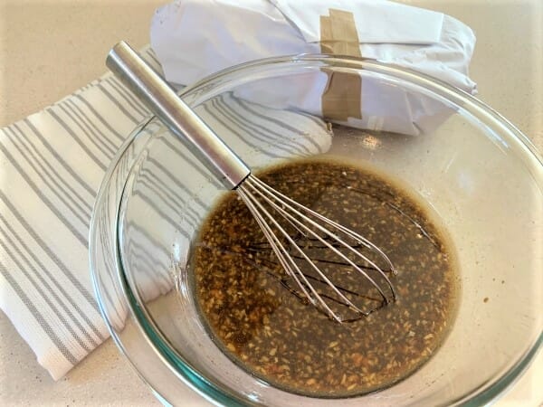 marinade in a bowl with a whisk